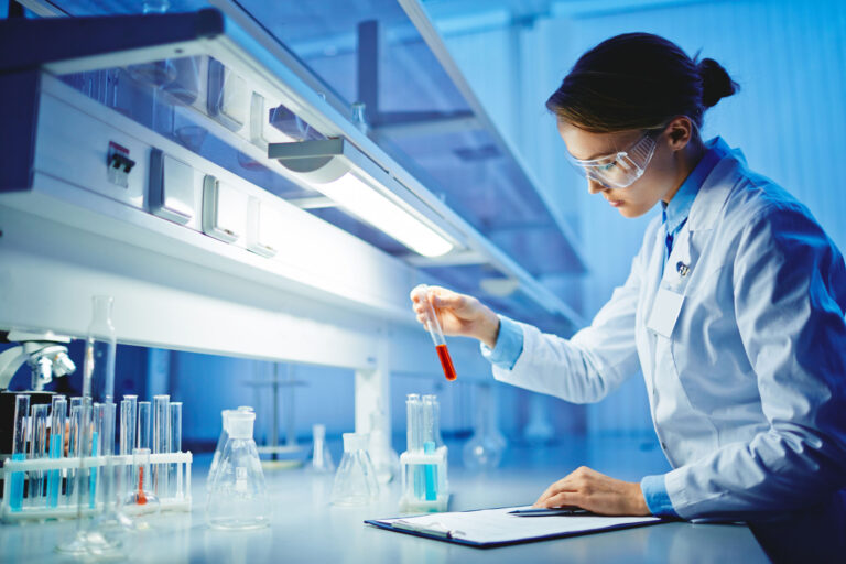 46624341 - young woman working with liquids in glassware