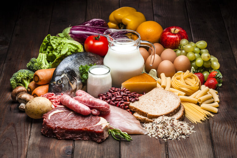 Different types of food on rustic wooden table