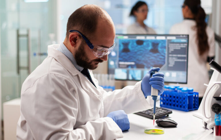 biochemistry-health-care-scientist-testing-blood-sample-using-micropipette